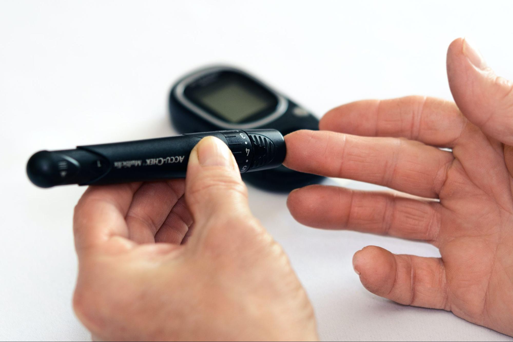 Clinical pharmacist's hand holding device to prick patient's finger