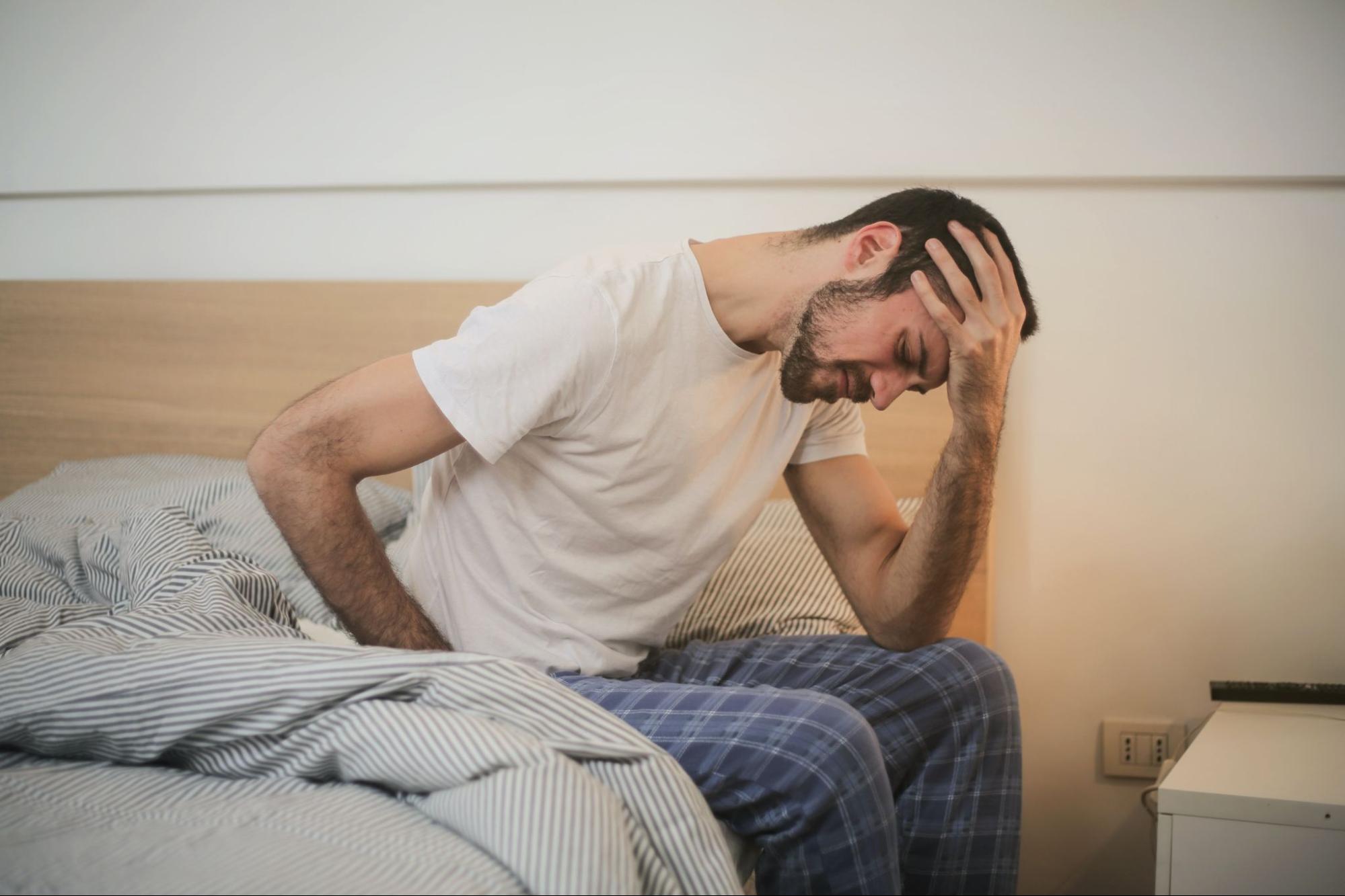 Tired man on bed before magnesium infusion