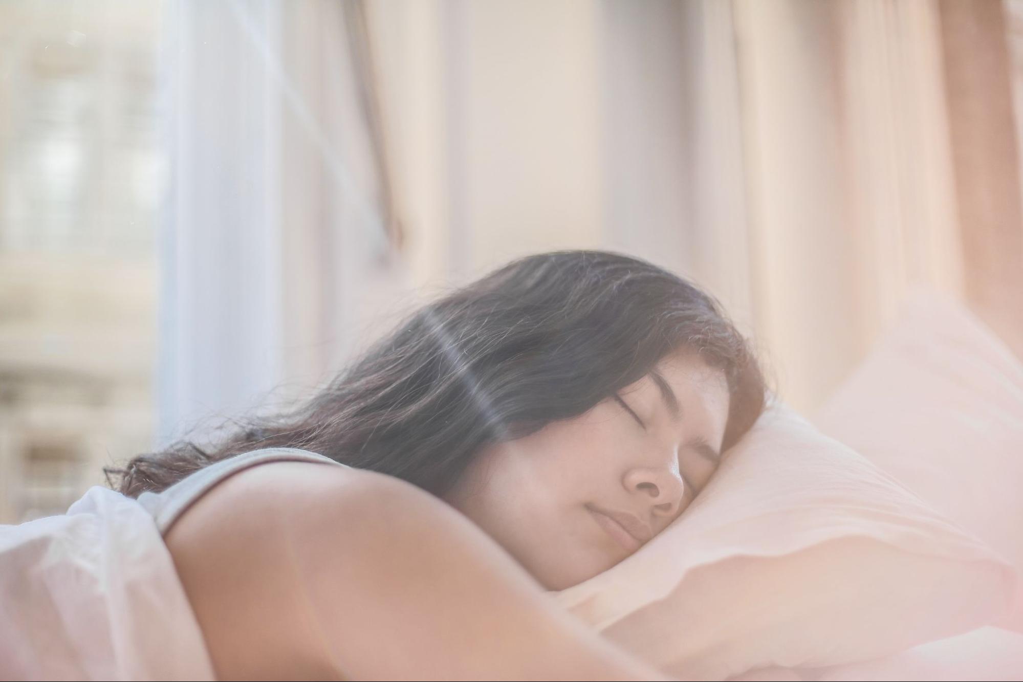 Woman sleeping to improve physical wellness