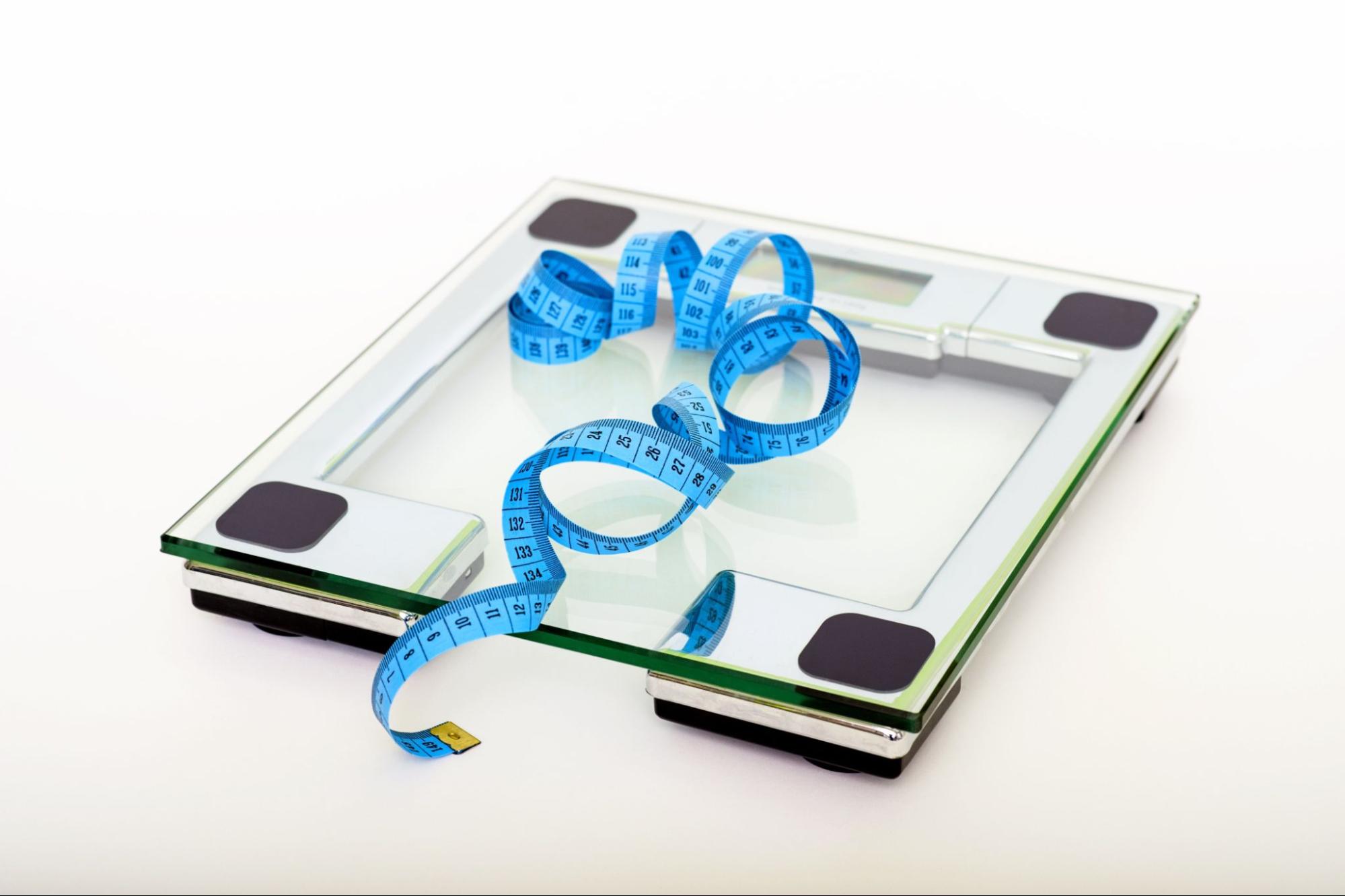 Scale and tape measure after weight loss meditation session