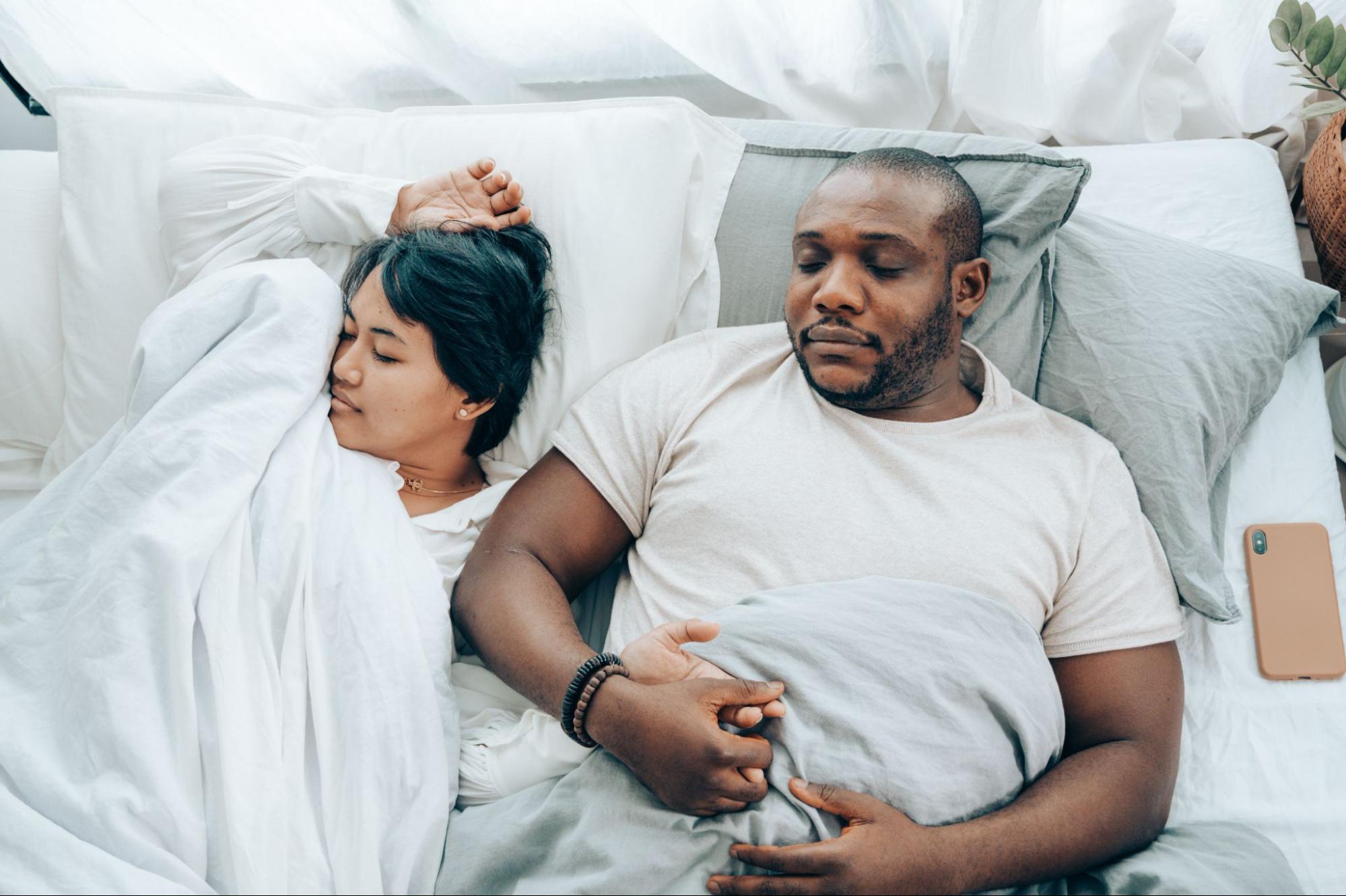 Interracial couple sleeping soundly after sleep hypnosis 