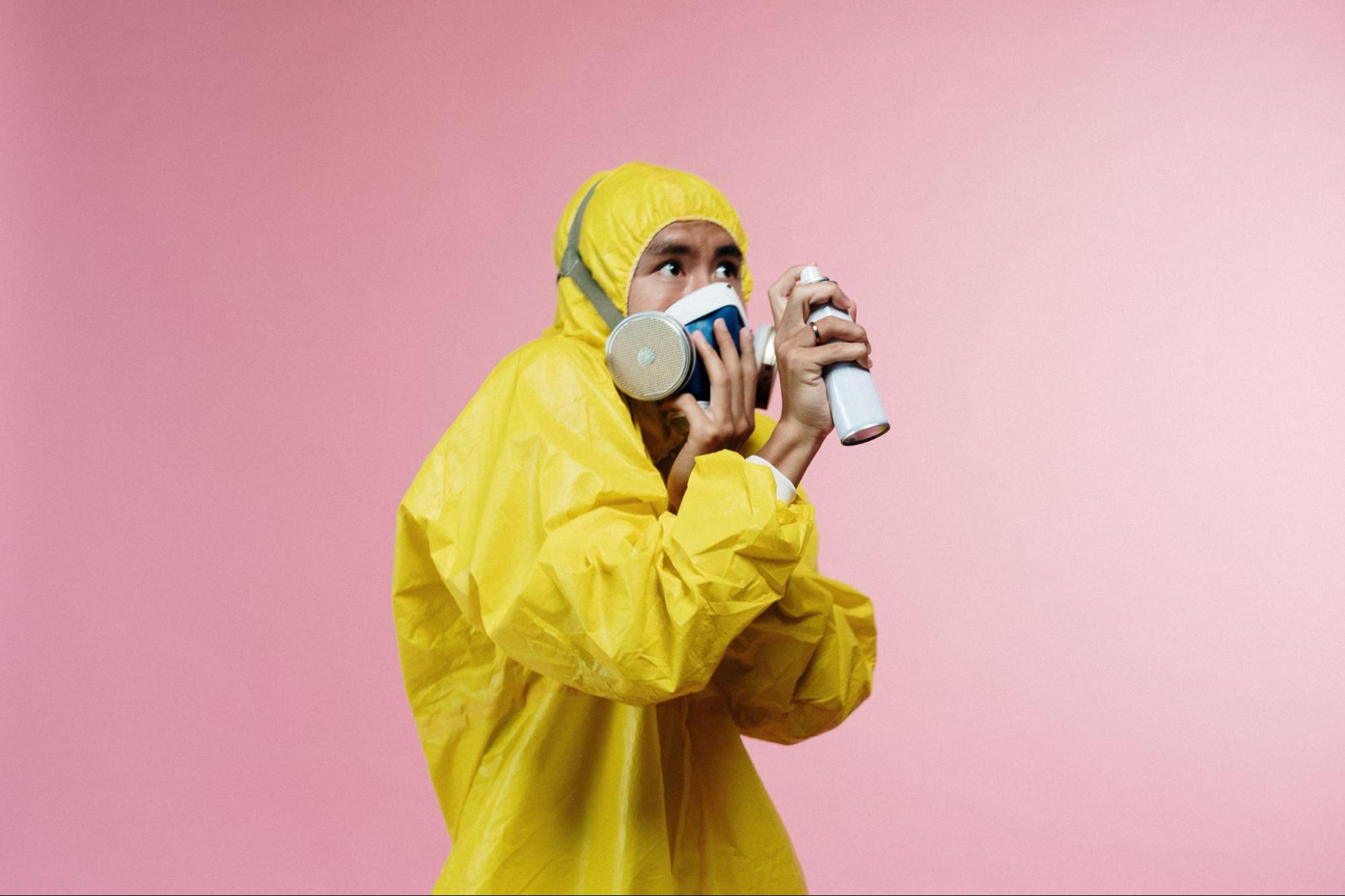 Man in hazmat suit using spray to avoid nasopharyngitis 