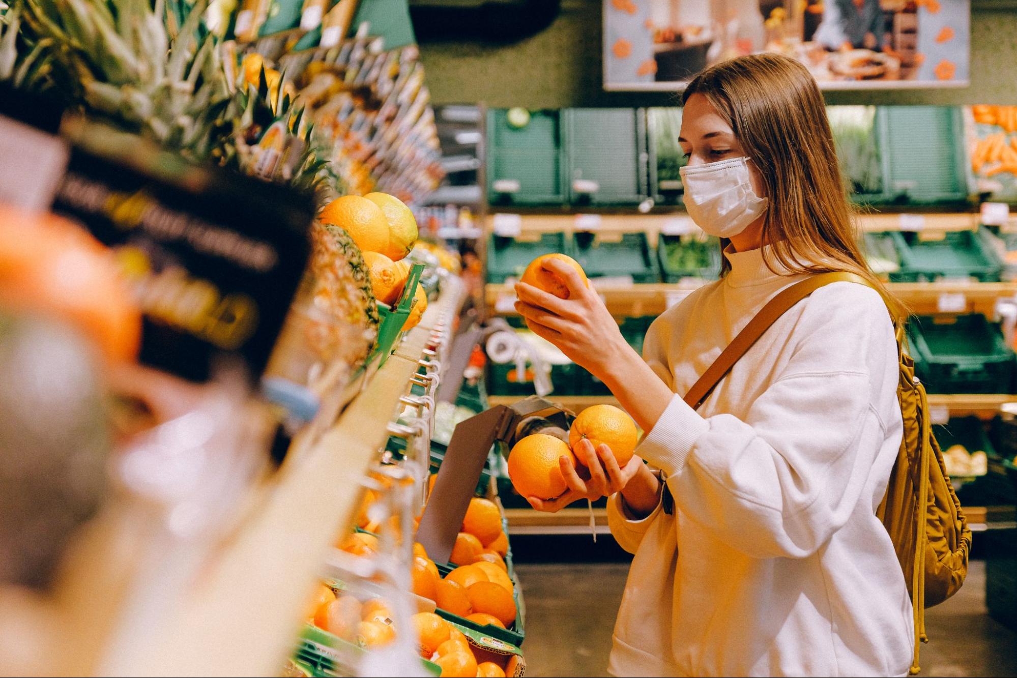 Woman buying fruit for plant-based meals